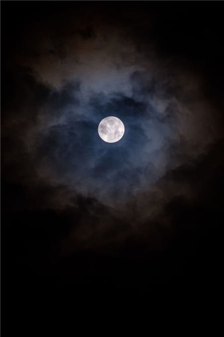 Hình ảnh ánh trăng tròn bị những áng mây đen phủ kín trên bầu trời làm hình nền điện thoại
