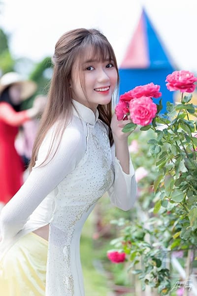 Xem hình ảnh cô gái xinh đẹp tạo dáng bên những bông hoa hồng đỏ thắm